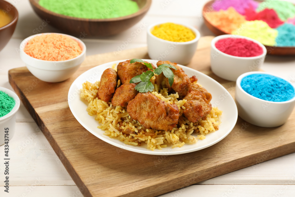 Traditional Indian food and color powders on white wooden table. Holi festival celebration Traditional Indian food and color powders on white wooden table. Holi festival celebration