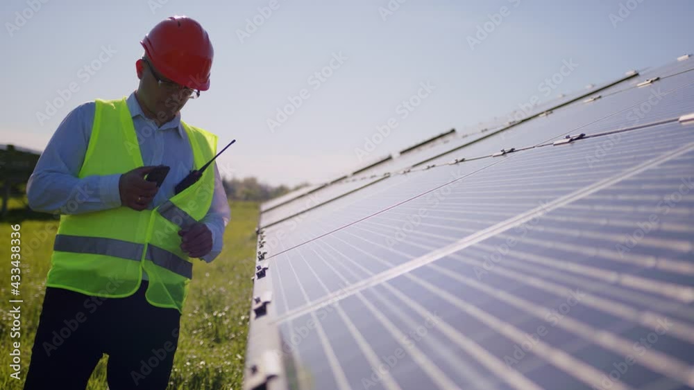 Engineer working use tablet near solar batteries construction renewable power worker man technology modern electricity energy slow motion Engineer working use tablet near solar batteries construction renewable power worker man technology modern electricity energy slow motion