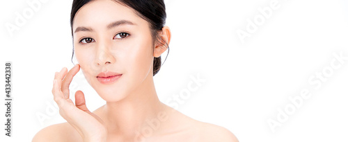 Closeup portrait of beauty asian woman with fair perfect healthy glow skin hand touching cheek isolated on white, young beautiful asia girl with pretty smile on face. Beauty korean spa skincare banner