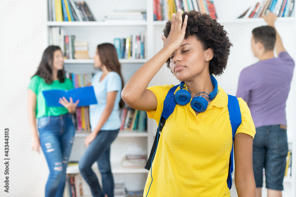 Beautiful afro american female student with hand on head as symbol for failure