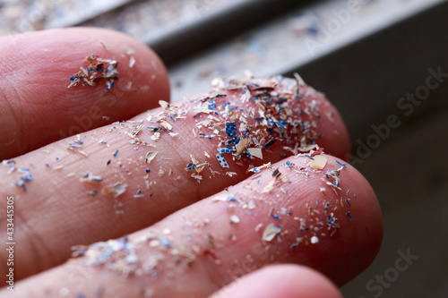 Close up side shot of microplastics lay on people hand.Concept of water pollution and global warming. Climate change idea. photo
