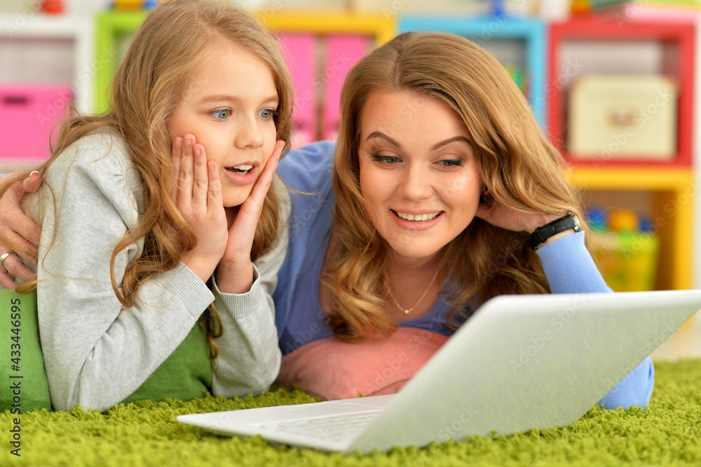 happy mother and daughter using laptop together happy mother and daughter using laptop together