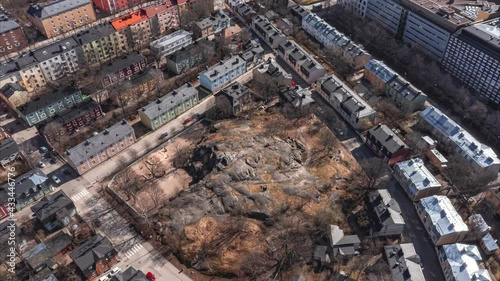 Aerial hyperlapse of the rocky hill in Puu Vallila neighborhood of Helsinki, Finland. Puu Vallila is a historical residential wooden district of Central Helsinki. Puu in Finnish is wooden.