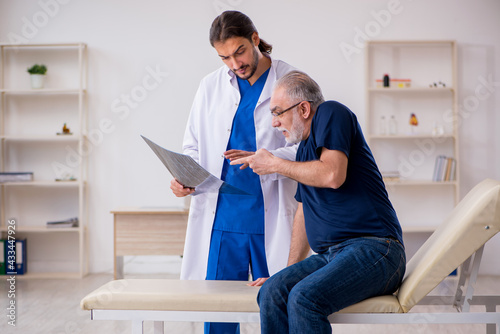 Old male patient visiting young male doctor radiologist © Elnur