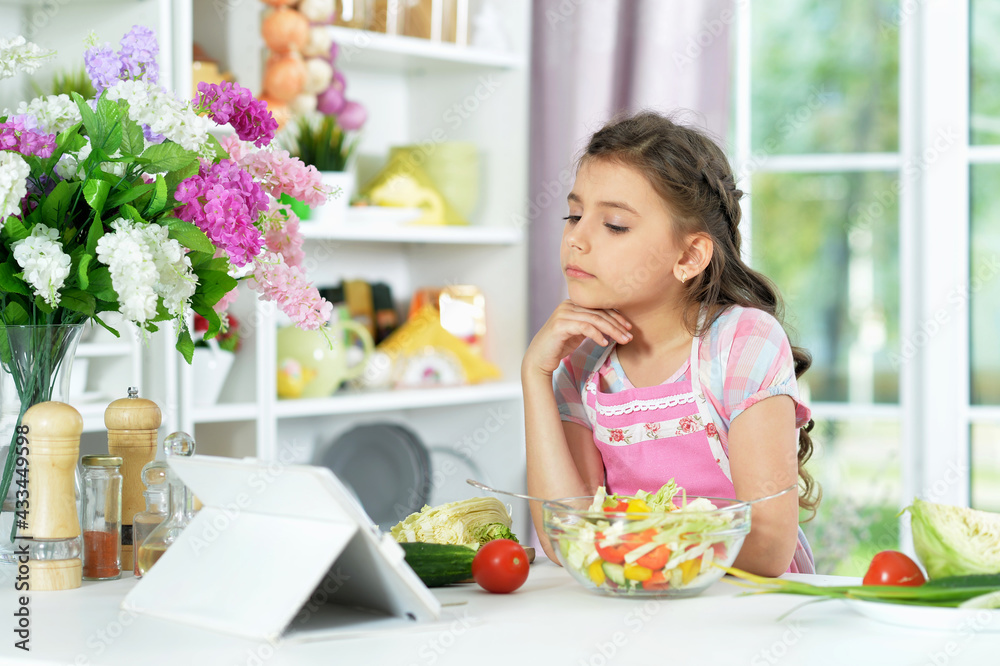 Cute little girl preparing fresh salad Cute little girl preparing fresh salad