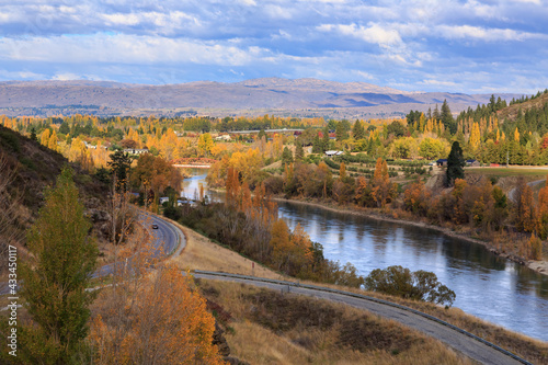 The Clutha River in the South Island of New Zealand as it flows into the small town of Clyde. Photographed in autumn