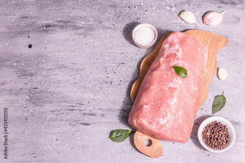 Raw pork loin on a chopping board