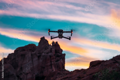 drone flying at sunset, with mountainous background