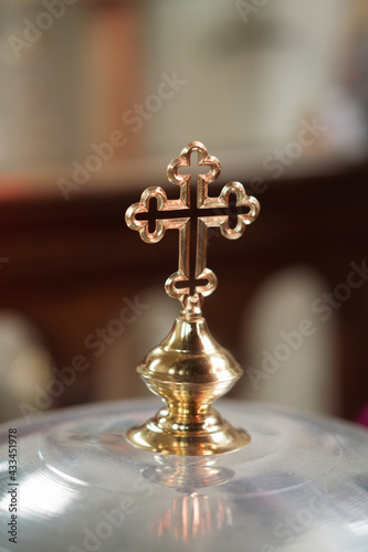 Fototapet Vertical shot of  a cross of a baptismal font