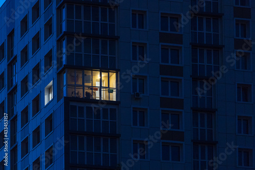 the light burns in one window of the multitude in a multi-storey residential building