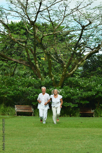 Happy senior woman and man in park