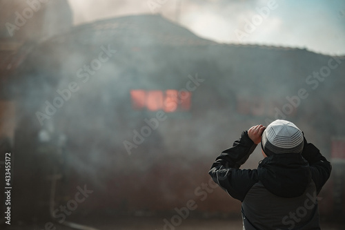 the fire destroys the building. the fire brigade pours water on the burning house. people are suffocating from the smoke and smog from the fire. fire victims