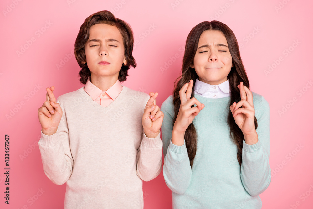 Portrait of attractive dreamy worried kids crossed fingers expecting praying isolated over pink pastel color background Portrait of attractive dreamy worried kids crossed fingers expecting praying isolated over pink pastel color background