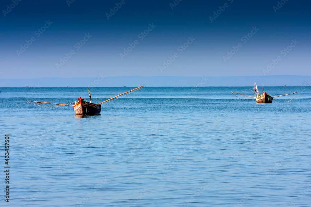 Small fishing boats in the Bay of Mui Ne, Vietnam, Southeast Asia