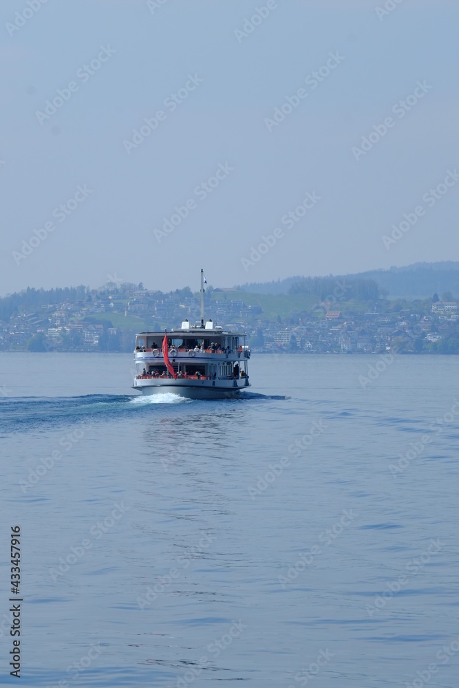 A ferry boat on the Lucern lake a view from the beautiful small city of Vitznau. The 27th April 2021, Switzerland.