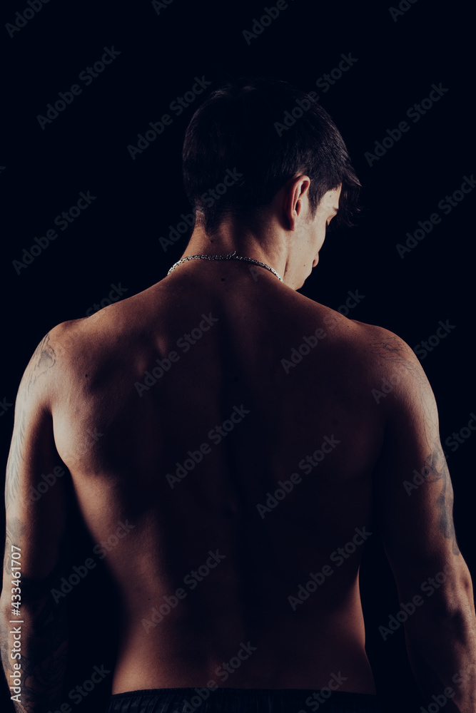 back of a young man with tattoos back of a young man with tattoos