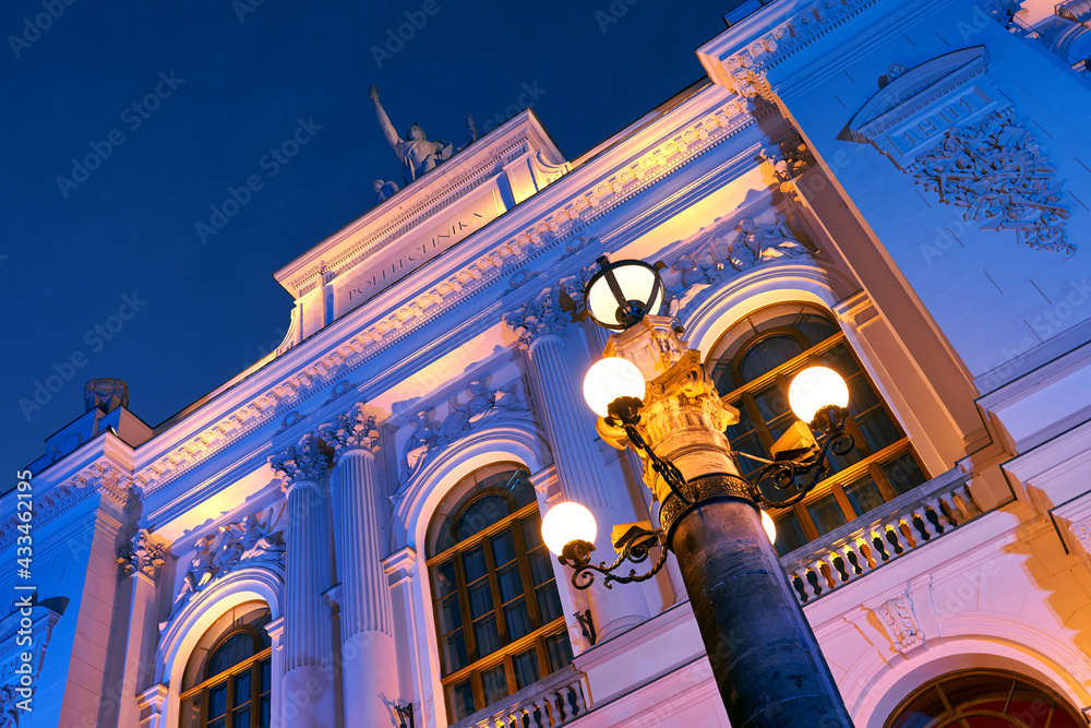 Detailds of the main building of Warsaw University of Technology at dusk lit by colorful lights. Warsaw, Poland.