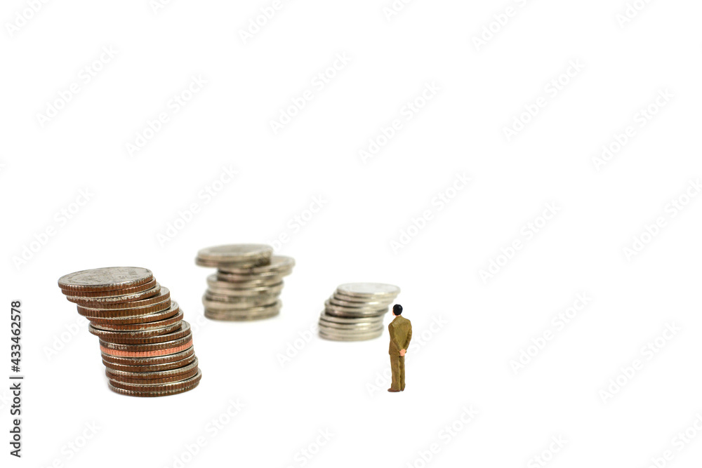 Miniature figures businessman on coins, on the white backgroud. Miniature figures businessman on coins, on the white backgroud.