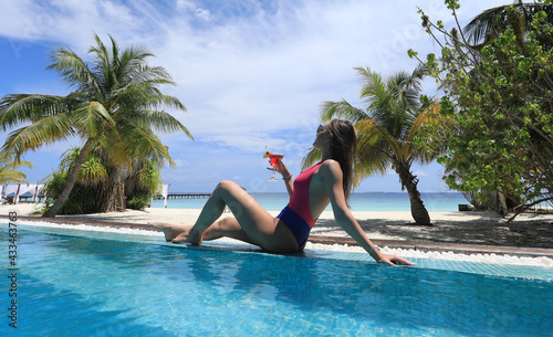 girl in bikini with cocktail in tropical pool © serikbaib