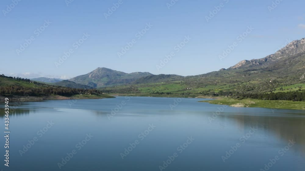 Rosamarina lake in Caccamo near Palermo. It is among the largest lakes in Sicily. Sport fishing and water sports in Sicily. Lake surrounded by rich vegetation. Rosamarina lake in Caccamo near Palermo. It is among the largest lakes in Sicily. Sport fishing and water sports in Sicily. Lake surrounded by rich vegetation.