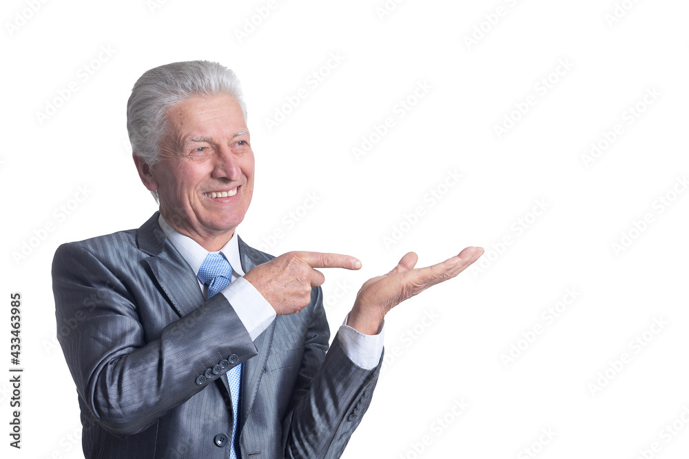 portrait of senior businessman wearing suit pointing