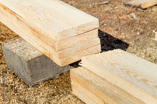 Wooden building materials: cut wood boards on a construction site photo