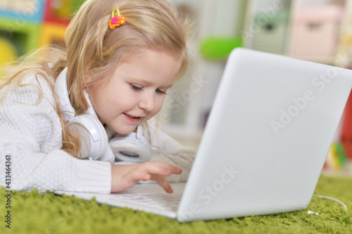 girl with headphones using laptop
