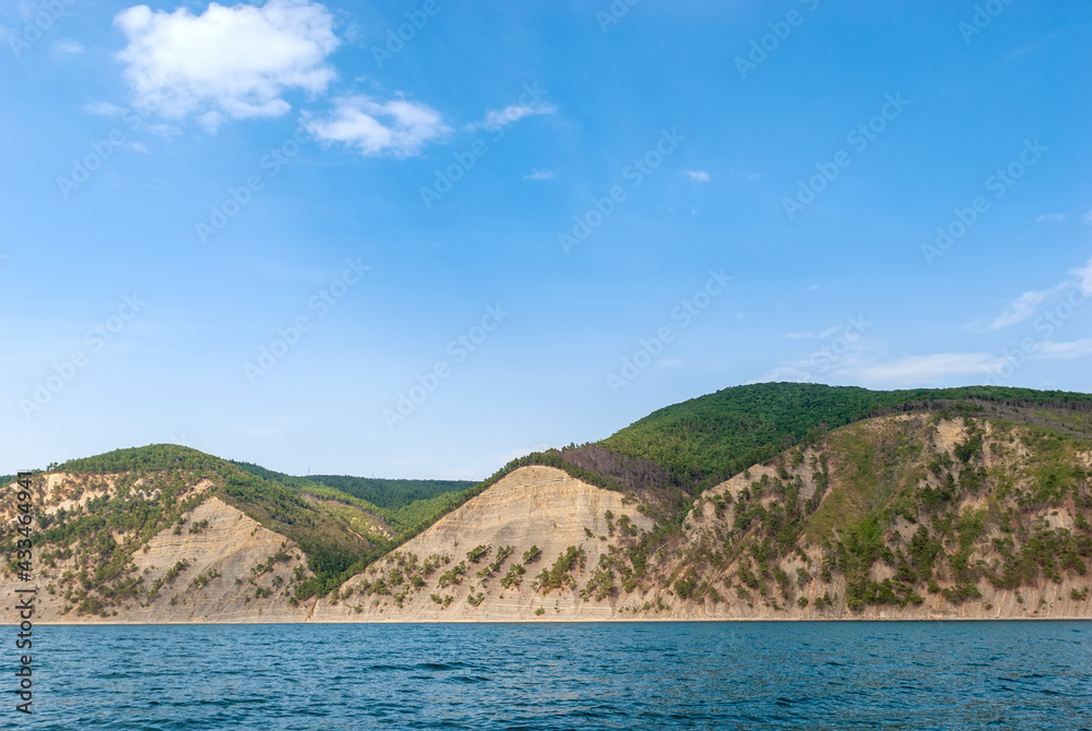 Mountain seascape. Turquoise water, pine mountains and blue skies. Mountain seascape. Turquoise water, pine mountains and blue skies.