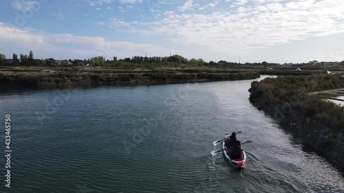 young couple canoeing on the Traict, Le Croisic, Brittany, France, close to the entrance of the salt march of Guerande
 photo