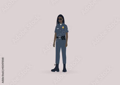 A young female Black police officer on duty wearing a uniform and sunglasses