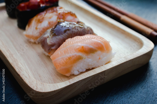 Zushi set is a Japanese dish that is placed on a wooden plate to add beauty to it even more.