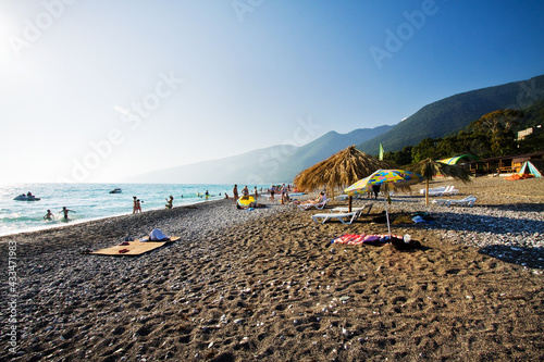 Beach against the backdrop of mountains. Sunny day. Blue sky. Black Sea.