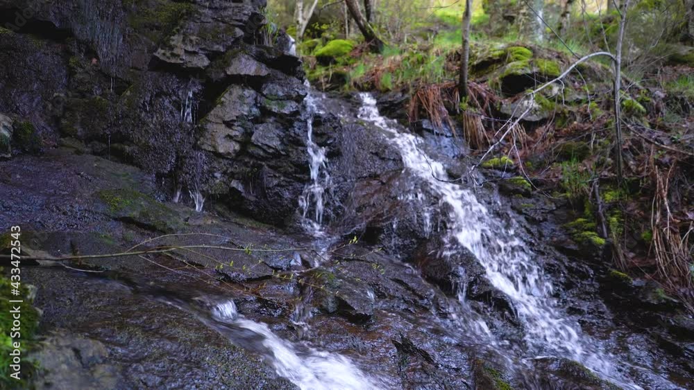 Beautiful waterfall falling between the rocks in the enchanted forest. Guadarrama Madrid. Beautiful waterfall falling between the rocks in the enchanted forest. Guadarrama Madrid.