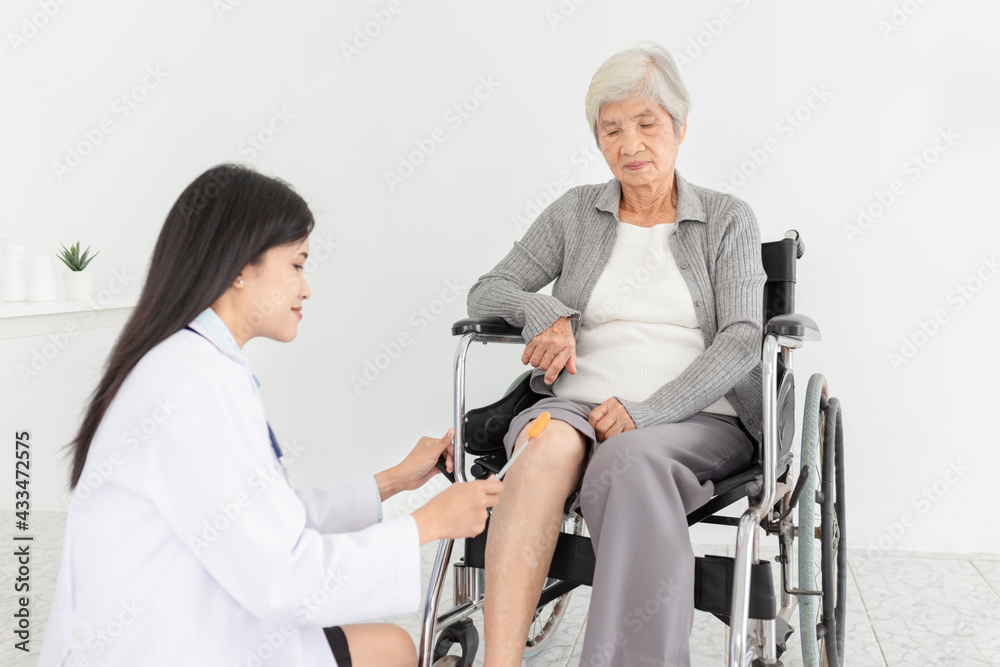 smart asian female doctor use hammer jerk hit to knee of patient, she