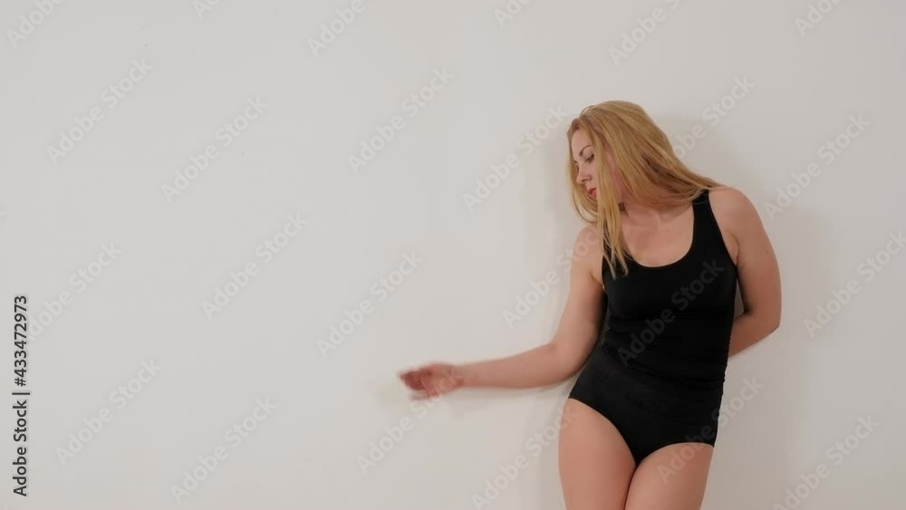 A young sexy woman in a striptease shoes dances a sensual dance in dance studio. A young sexy woman in a striptease shoes dances a sensual dance in dance studio.