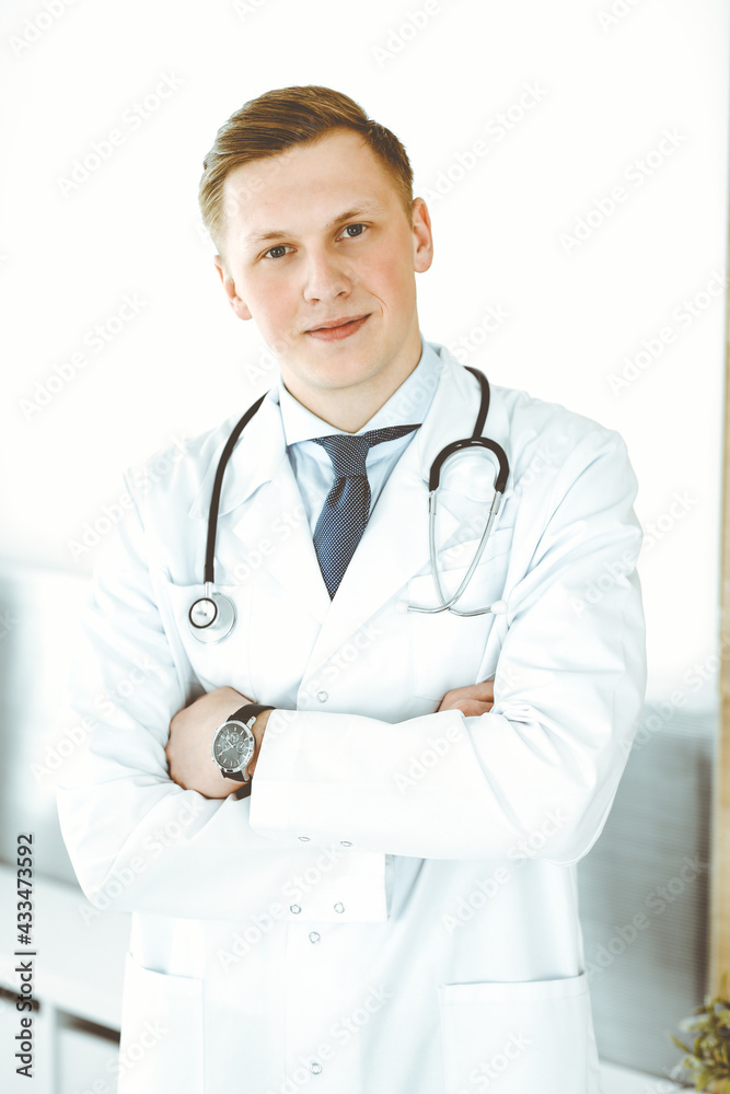 Doctor man standing straight in medical office or clinic. Medicine concept Doctor man standing straight in medical office or clinic. Medicine concept