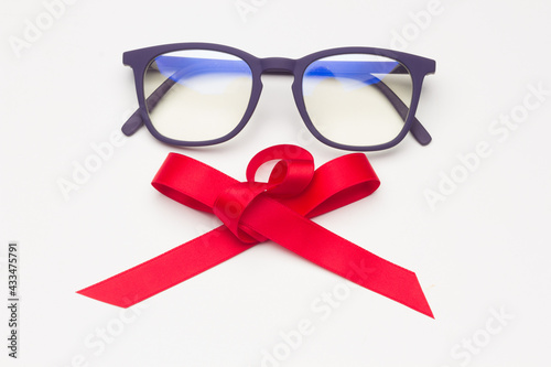 Black plastic glasses with a red bow