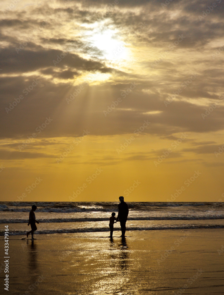 Father with children at sunset on beach Father with children at sunset on beach
