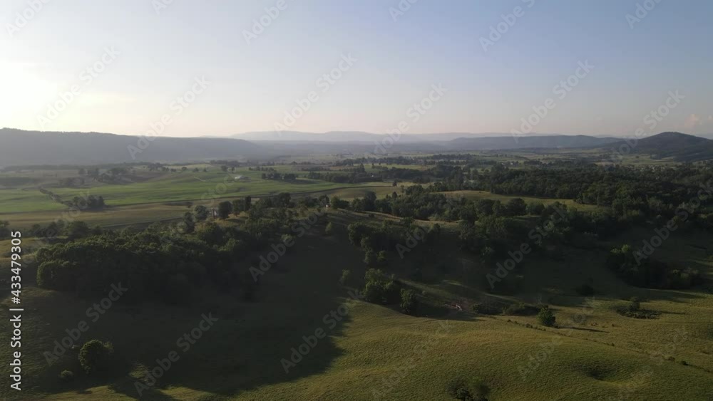 Long Push-In Aerial Shot Over Farm Land at Sunset Long Push-In Aerial Shot Over Farm Land at Sunset