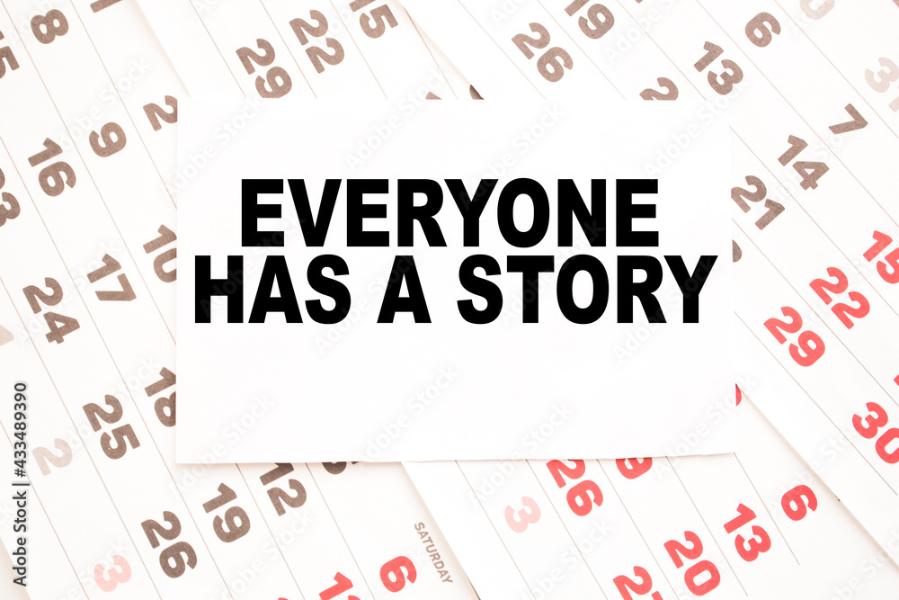Notepad with text EVERYONE HAS A STORY on the office desk with stationery. A blank notepad for entering a copy or text. business Notepad with text EVERYONE HAS A STORY on the office desk with stationery. A blank notepad for entering a copy or text. business