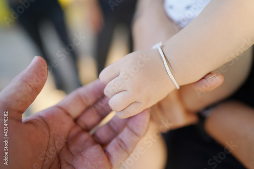 Parents and kid hands together