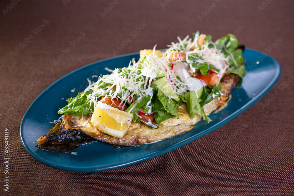 salad on baked banana with vegetables and herbs on a blue plate