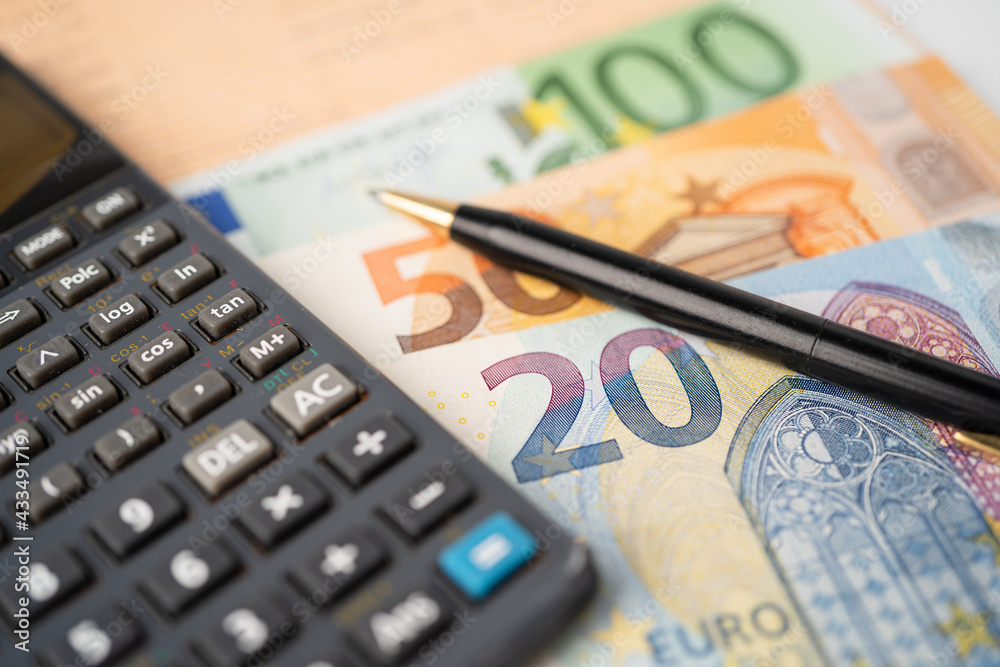 Euro banknotes money with calculator on chart graph paper. Financial development, Banking Account, Statistics, Investment Analytic research data economy, trading, Business company concept. Euro banknotes money with calculator on chart graph paper. Financial development, Banking Account, Statistics, Investment Analytic research data economy, trading, Business company concept.