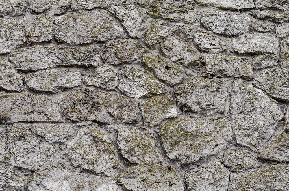 Stone wall made of gray natural untreated stone. Ancient medieval castle Stone wall made of gray natural untreated stone. Ancient medieval castle