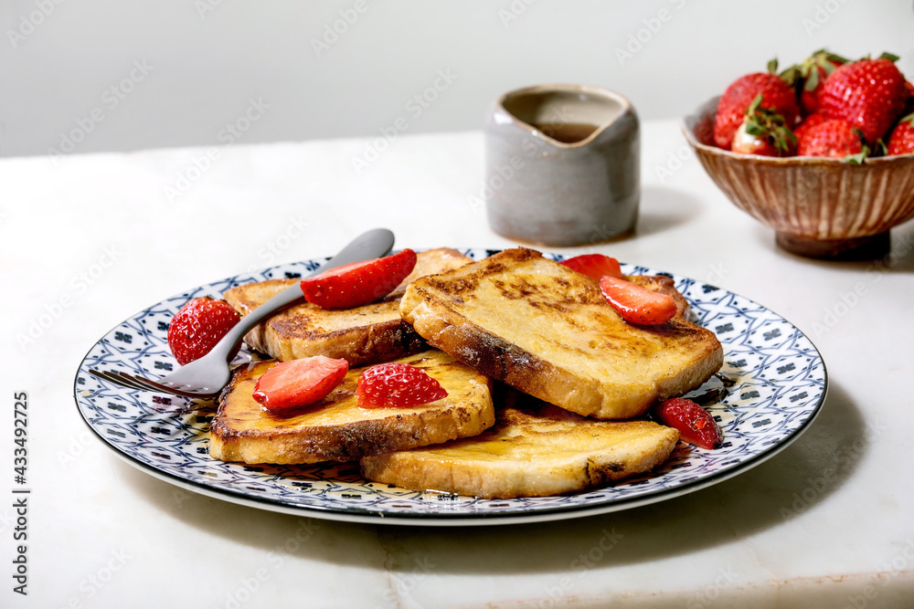 Stockpile of french toasts with fresh strawberries