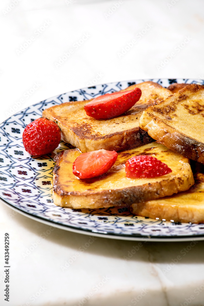 Stockpile of french toasts with fresh strawberries