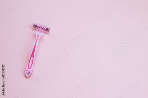 Pink woman razor on pink background. pink shaver . smooth body skin photo