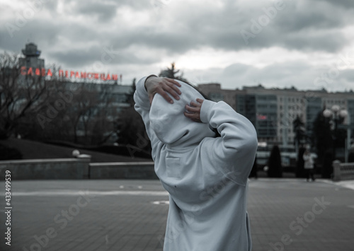 man in white bike with hoods with arms up