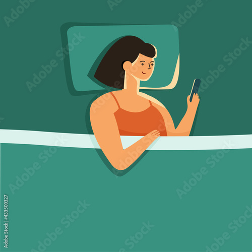 woman lying alone in bed night, using smartphone