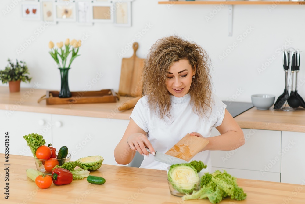 Young woman preparing vegetable salad in her kitchen. Healthy lifestyle concept beautiful woman with mixed vegetable. Young woman preparing vegetable salad in her kitchen. Healthy lifestyle concept beautiful woman with mixed vegetable.